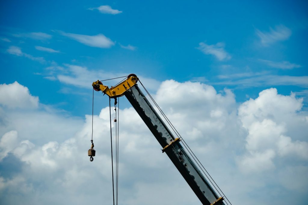 a crane is lifting a piece of equipment into the air